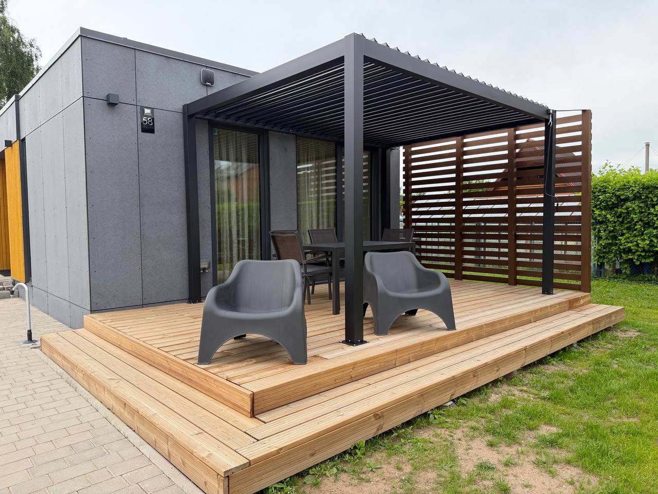 Wood deck terrace with bioclimatic pergola and seating — N58 Carnikava